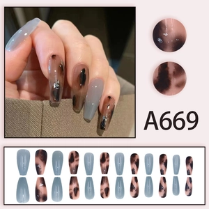 Press-on nail set in amber and fog blue with silver foil accents in long coffin shape