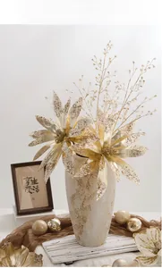 Champagne gold artificial poinsettia flower with sequins in a ceramic vase for Christmas