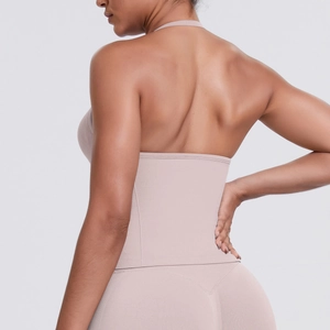 Detail view of the seamless backless halter yoga top and high-waisted leggings in skin tone