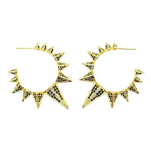 Detail of gold spike hoop earrings featuring pave deep blue crystals and a gothic aesthetic
