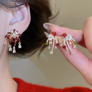 Detail of vintage gold-plated zircon firework earrings with enamel flowers and pearls