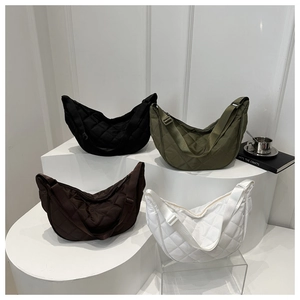 Detailed display of four quilted crescent bags in black, green, brown, and white colors