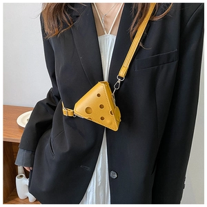 Detail showing cheese shaped yellow mini crossbody bag with unique hole pattern