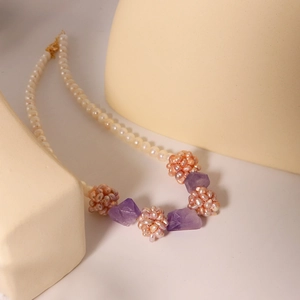 Elegant freshwater pearl necklace with amethyst beads and a pink woven floral pendant