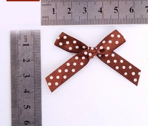 Polka dot satin bow ribbon in brown color measured with a ruler for 4.5cm width