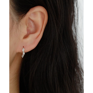 Close-up of minimalist S925 silver hoop earring with marquise zircon on model's ear