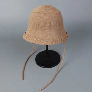 Detail showing soft knit texture and long ribbon ties of the camel bucket hat