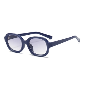 Retro oval sunglasses with thick deep blue frames and grey-purple gradient lenses