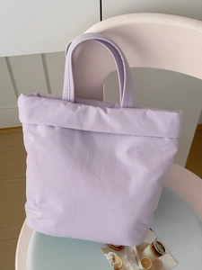 Close-up of lavender padded tote bag hanging on chair in a lifestyle scene