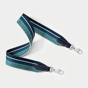 Close-up of ethnic geometric woven shoulder strap with blue leather and silver metal clips