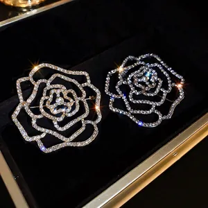 Exquisite hollow camellia brooches with sparkling rhinestones in gold and silver finish