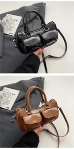 Detail of glossy vintage saddle bag showing adjustable straps and stylish dual pockets