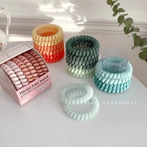 Set of 6 matte gradient spiral hair ties in a pastel box with minimalist decor