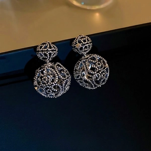 Silver hollow sphere earrings featuring intricate metal mesh and elegant French design