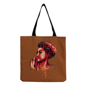 Detailed view of brown canvas tote bag featuring artistic female silhouette print