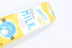 Detail of yellow banana milk carton pencil case with high-quality PU leather texture