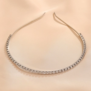 Detailed macro view of an emerald green zirconia headband with sparkling silver crystals