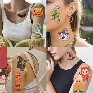 Close-up of Halloween temporary tattoos featuring bats, pumpkins and ghosts on skin