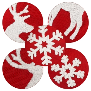 Large red knitted Christmas stocking featuring white snowflake and reindeer patterns
