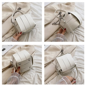 Detail views of off-white woven PU bucket bag with chain strap and metal feet