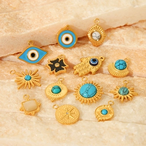 Detailed assortment of golden stainless steel pendants with turquoise and celestial motifs