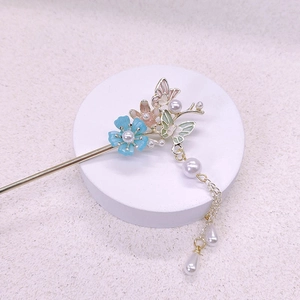 Ancient style butterfly flower hair pin with enamel detail and pearl tassel on white stand