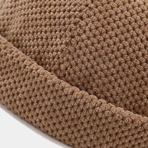 Close-up of deep brown waffle knit docker cap showing thick textured weave detail
