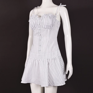 Detail view of striped mini dress featuring decorative buttons and ruffled bodice detail
