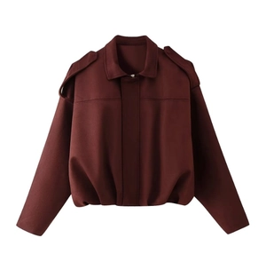 Detail of dark red cropped bomber jacket showing shoulder straps and classic lapel collar
