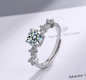 Macro shot of adjustable silver ring with sparkling round zirconia stones and polished band