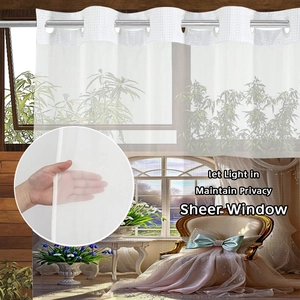 Detail of white sheer waffle fabric curtain showing light filtering and privacy features