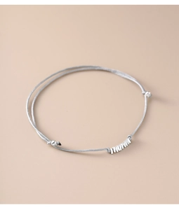 Detailed close-up of double-strand silver rope bracelet with adjustable metal bar charms