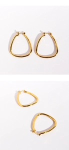 Detail view of 24k gold plated geometric triangle earrings with polished metallic finish