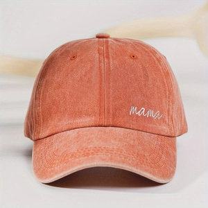Detail view of the white mama embroidery on a vintage brick red washed baseball cap