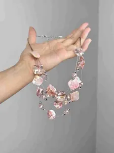 Detail of pink irregular beaded layers and silver beads on a multi-strand necklace