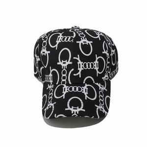 Detail of black baseball cap with white artistic lettering and graphic patterns
