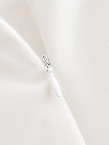 Detail of high-quality white hidden zipper on knitted dress fabric with macro focus