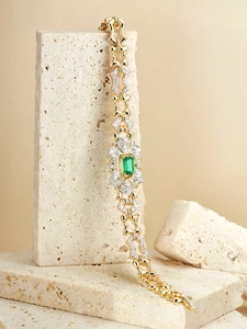 French vintage gold bracelet featuring emerald green gemstones and pave-set zircons