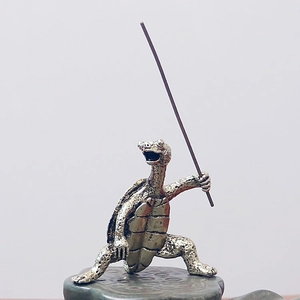 Macro detail of antique bronze kung fu turtle incense holder on a lotus pod base