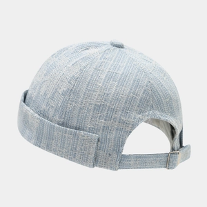 Close-up of vintage blue denim docker hat showing fabric texture and metal buckle adjustment