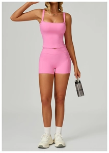 Pink yoga set detail featuring high-waisted shorts with V-cross waistband and side pockets