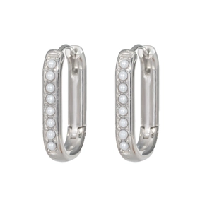 Macro detail of silver U-shaped earrings with inlaid white pearls on stainless steel
