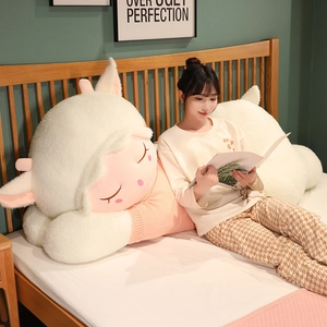 Detail view of large white plush sheep toy wearing a soft pink knitted turtleneck sweater