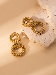 Detail of gold interlocking hoops and textured hollow circle stainless steel earrings