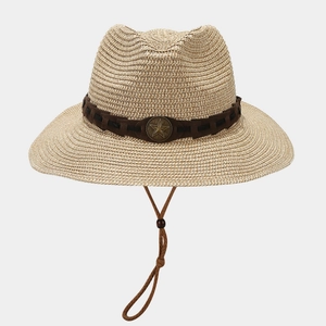 Detail of straw cowboy hat featuring vintage bronze star badge and adjustable wind cord