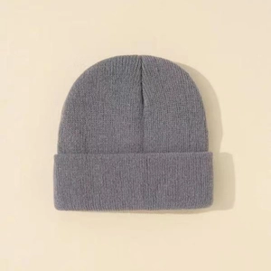 Close-up of gray knit beanie with ribbed texture and thick turnover cuff for winter