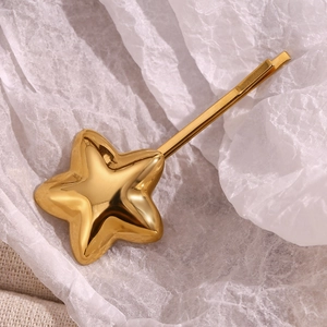 Close-up of a 3D 18K gold plated star hair clip with smooth polished metal finish