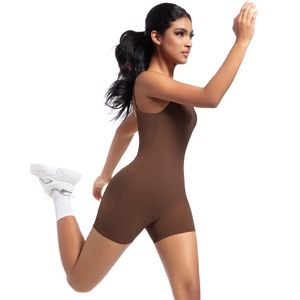 Side view of woman in brown stretch yoga romper and sneakers in a running pose