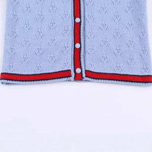 Light blue knit cardigan featuring hollow-out texture and striped contrast trim details