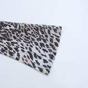 Close-up of leopard print mesh fabric showing breathable texture and double stitching